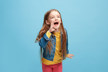 Image showing Isolated on pink young casual teen girl shouting at studio