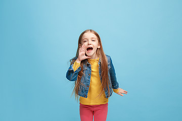 Image showing Isolated on pink young casual teen girl shouting at studio