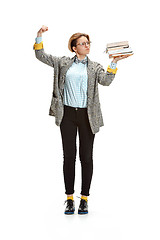 Image showing Full length portrait of a sad female student holding books isolated on white background