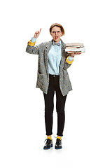 Image showing Full length portrait of a happy smiling female student holding books isolated on white background