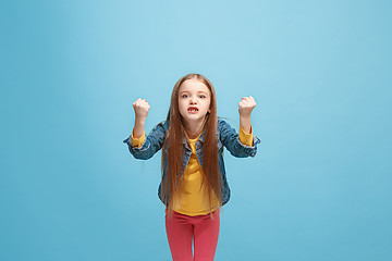 Image showing Portrait of angry teen girl on a blue studio background