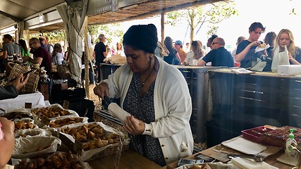 Image showing People are enjoying delicious food at a Neighbourgoods Market at the waterfront of Cape Town, South Africa.