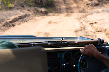 Image showing Safari guide driving with his rifle in the bush of South Africa