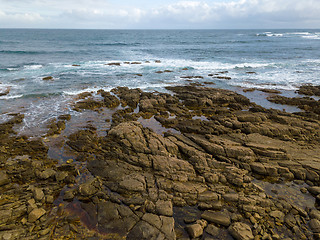 Image showing Aerial view of ocean waves and rocky coast