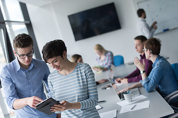 Image showing Two Business People Working With Tablet in office