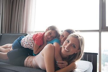 Image showing young mother spending time with kids on the floor