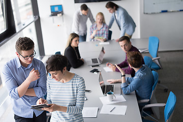 Image showing Two Business People Working With Tablet in office