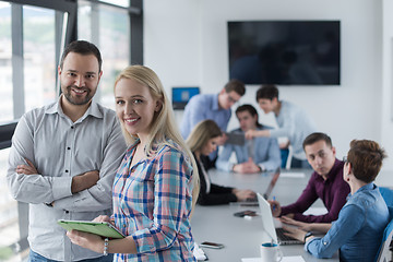 Image showing Two Business People Working With Tablet in office