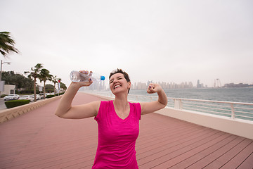 Image showing young woman celebrating a successful training run