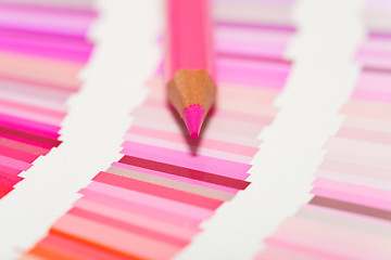 Image showing red and pink colored pencils and color chart of all colors