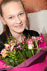Image showing happy girl with a bunch of flowers