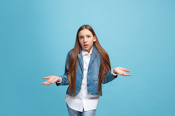 Image showing Beautiful teen girl looking suprised and bewildered isolated on blue