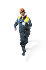 Image showing The studio shot of senior bearded male miner standing at the camera on a white background.