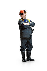 Image showing The studio shot of senior bearded male miner standing at the camera on a white background.