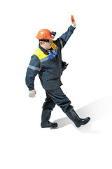 Image showing The studio shot of senior bearded male miner standing at the camera on a white background.