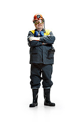 Image showing The studio shot of senior bearded male miner standing at the camera on a white background.