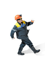 Image showing The studio shot of senior bearded male miner standing at the camera on a white background.