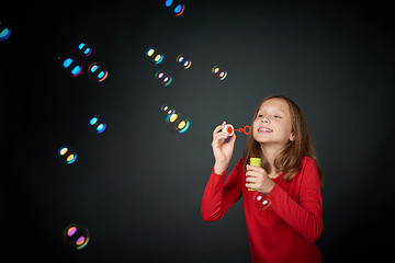 Image showing Girl blowing soap bubbles