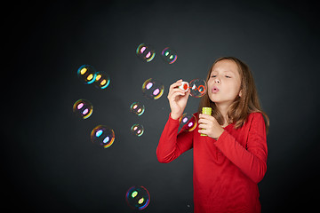 Image showing Girl blowing soap bubbles