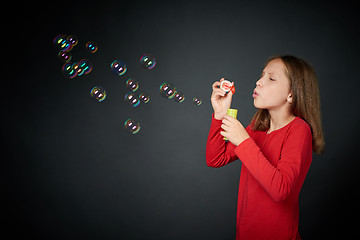 Image showing Girl blowing soap bubbles