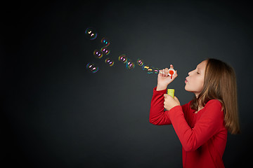Image showing Girl blowing soap bubbles