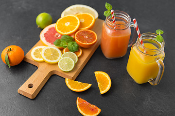 Image showing mason jar glass with juice and fruits on table