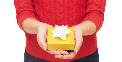 Image showing close up of woman in red sweater holding gift box