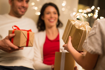 Image showing close up of family with christmas gifts at home