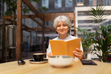 Image showing senior woman with coffee at street cafe