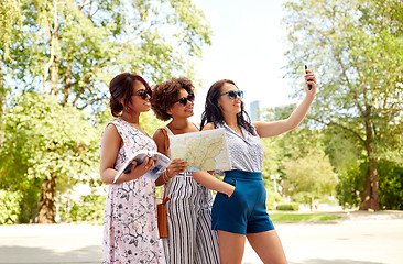 Image showing women with city guide and map taking selfie