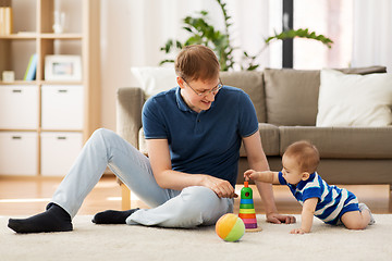 Image showing happy father with little baby son playing at home