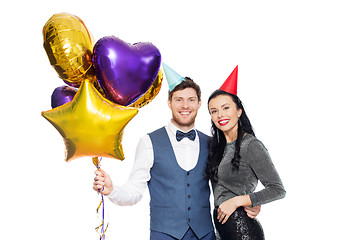 Image showing happy couple with party caps and balloons