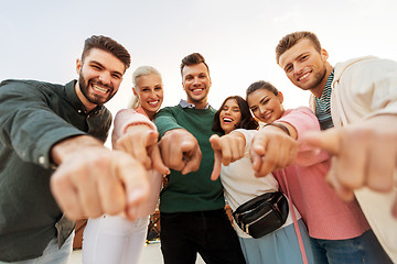 Image showing happy friends pointing finger at you