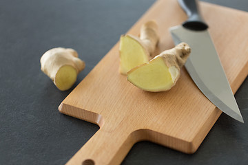 Image showing close up of ginger root and knife on cutting board