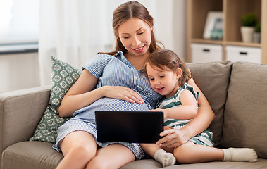 Image showing pregnant mother and daughter with tablet pc