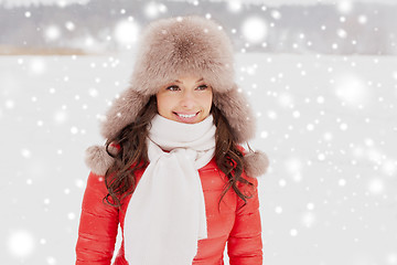 Image showing happy woman in winter fur hat outdoors