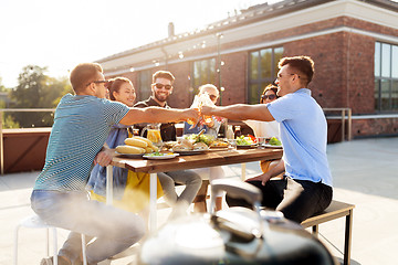 Image showing friends toast drinks at barbecue party on rooftop