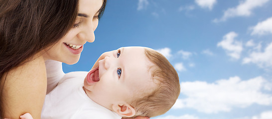 Image showing mother with baby over sky background