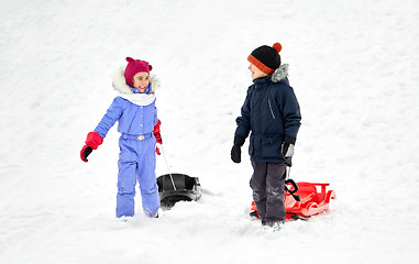 Image showing happy little kids with sleds in winter