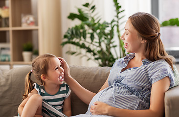 Image showing pregnant mother and daughter at home