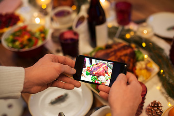 Image showing hands photographing food at christmas dinner