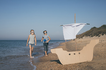 Image showing Happy children playing on the beach at the day time.