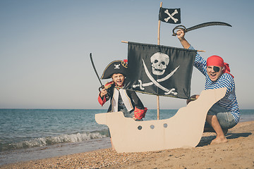 Image showing Father and son playing on the beach at the day time.