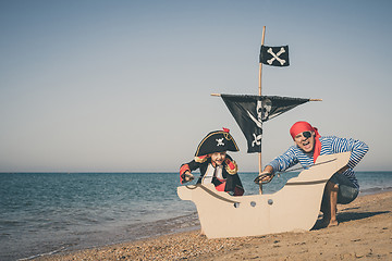 Image showing Father and son playing on the beach at the day time.