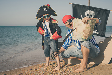 Image showing Father and son playing on the beach at the day time.