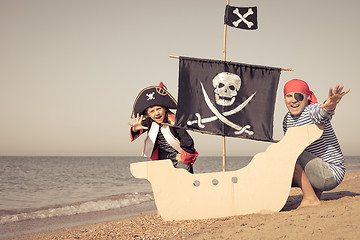 Image showing Father and son playing on the beach at the day time.