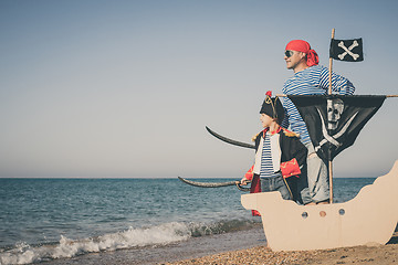 Image showing Father and son playing on the beach at the day time.