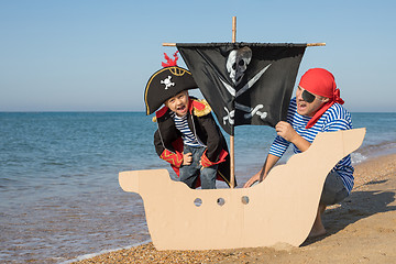 Image showing Father and son playing on the beach at the day time.