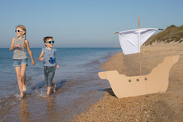 Image showing Happy children playing on the beach at the day time.