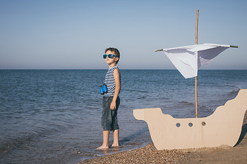 Image showing One happy little boy playing on the beach at the day time.